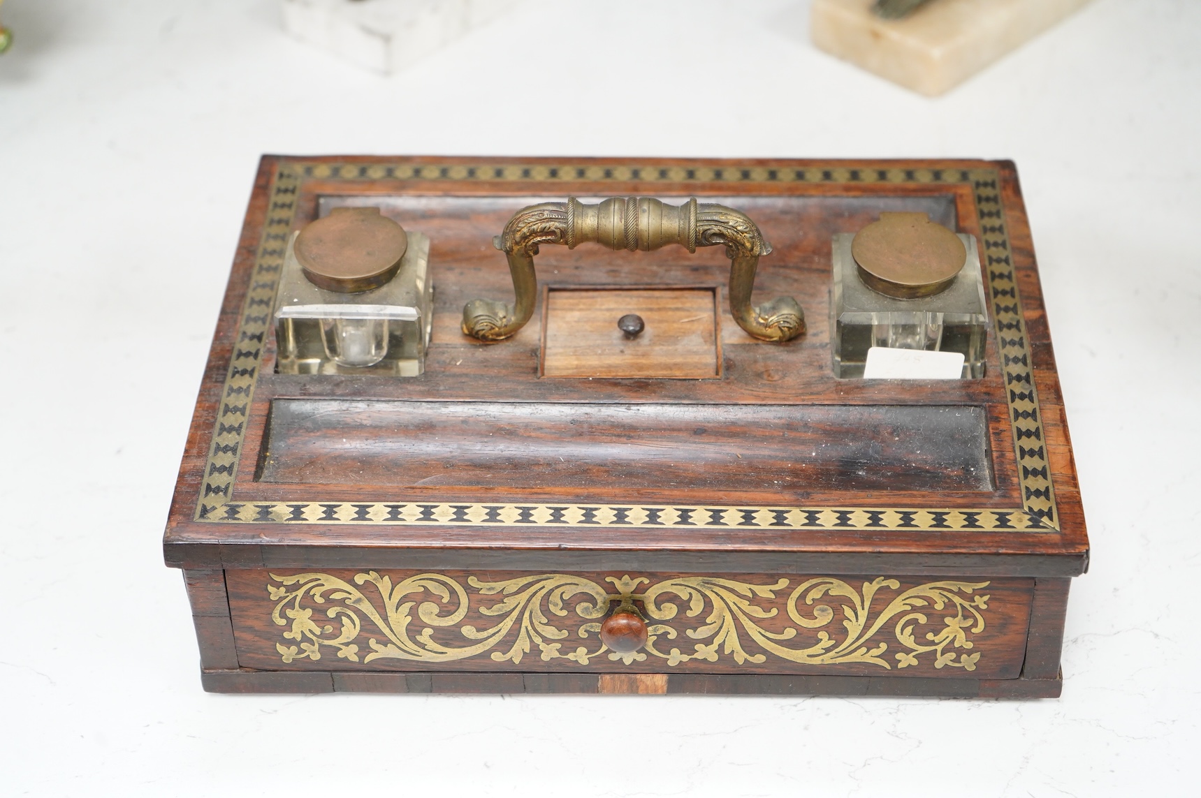 A George IV rosewood and cut brass inlaid two desk top inkstand, 29cm wide x 22cm deep